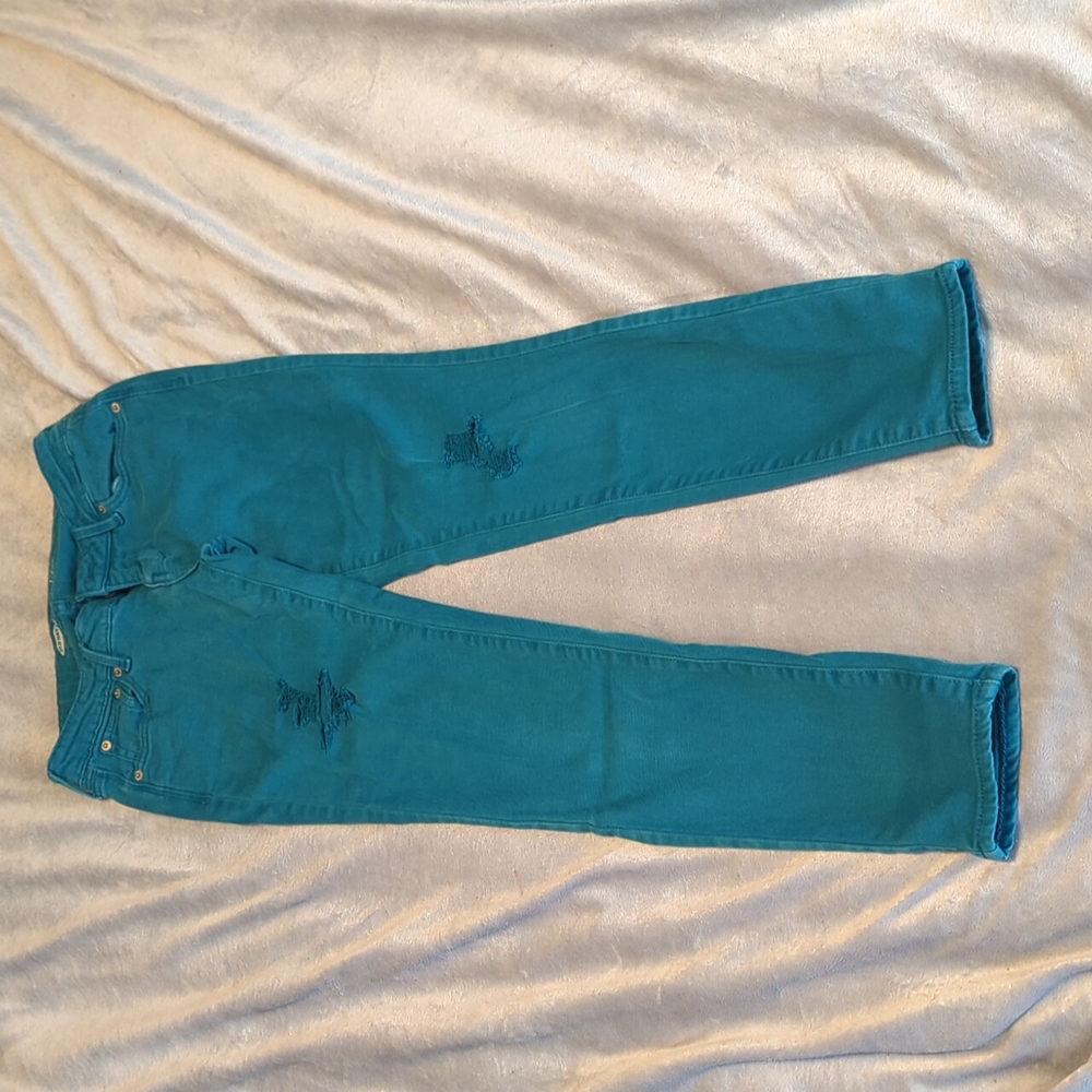 Distressed teal skinny jeans